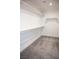 Carpeted walk-in closet offers ample storage space with built-in shelving and rods at 1703 Game Garden Rd, North Las Vegas, NV 89031
