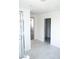 Hallway featuring light tile flooring and doorways leading to different rooms at 1703 Game Garden Rd, North Las Vegas, NV 89031