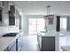 Stylish kitchen featuring white countertops, gray cabinets, stainless steel appliances, and an island at 1703 Game Garden Rd, North Las Vegas, NV 89031