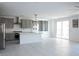 Bright kitchen and dining space with tile flooring, a center island, and modern stainless steel appliances at 1703 Game Garden Rd, North Las Vegas, NV 89031
