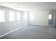 An airy living space boasts neutral walls, soft gray carpet, and a staircase with white railings at 1703 Game Garden Rd, North Las Vegas, NV 89031