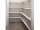 Walk-in pantry with white shelving and tile flooring, providing ample storage space for groceries at 1703 Game Garden Rd, North Las Vegas, NV 89031