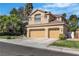 Spacious two-story home with a three car garage, tile roof, and mature landscaping at 1717 Double Arch Ct, Las Vegas, NV 89128