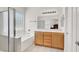 Bathroom featuring a tub, shower, double sink vanity, and plenty of natural light at 209 Prairie Creek St, Henderson, NV 89012