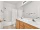 Well-lit bathroom showcasing a double sink vanity, tiled walls, and a shower-tub combo at 209 Prairie Creek St, Henderson, NV 89012