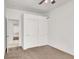 Bright bedroom with carpeted floors, closet with sliding doors, and a ceiling fan at 209 Prairie Creek St, Henderson, NV 89012
