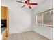 Bright dining area with a ceiling fan, large window, and tile flooring at 209 Prairie Creek St, Henderson, NV 89012