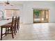Open dining area with tile flooring, breakfast bar, and sliding glass door to the backyard at 209 Prairie Creek St, Henderson, NV 89012