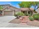 Well-maintained single-story home with a two-car garage and attractive desert landscaping at 209 Prairie Creek St, Henderson, NV 89012