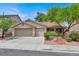 Charming single-story home featuring a two-car garage, desert landscaping, and a tile roof at 209 Prairie Creek St, Henderson, NV 89012