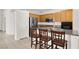 Bright, open kitchen with stainless steel appliances, granite counters, and breakfast bar at 209 Prairie Creek St, Henderson, NV 89012