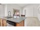 View of kitchen island with stainless steel dishwasher and sliding glass doors at 209 Prairie Creek St, Henderson, NV 89012