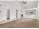 Open living room with a ceiling fan, bright white walls, and adjoining dining area at 209 Prairie Creek St, Henderson, NV 89012