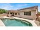 Inviting backyard pool with a baja step, surrounded by lush landscaping at 209 Prairie Creek St, Henderson, NV 89012