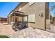 Backyard with a built-in BBQ, covered seating area, and well-maintained landscaping at 2189 De Narvik Dr, Henderson, NV 89044