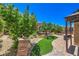 Manicured backyard with garden, turf, gazebo with seating area, and walkways at 2189 De Narvik Dr, Henderson, NV 89044