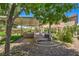 Spacious backyard featuring a built-in grill, a covered patio, and lush landscaping at 2189 De Narvik Dr, Henderson, NV 89044