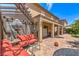 A spacious backyard with a covered patio, outdoor seating, and lush landscaping at 2189 De Narvik Dr, Henderson, NV 89044