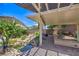 Inviting backyard with a covered patio, tranquil water feature, and beautiful brickwork at 2189 De Narvik Dr, Henderson, NV 89044