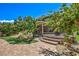 Stunning backyard showcasing a charming patio, rock water feature, and mature trees at 2189 De Narvik Dr, Henderson, NV 89044