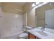 Bright bathroom with a shower-tub combo, white tile, and a vanity with sink at 2189 De Narvik Dr, Henderson, NV 89044