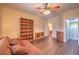 Inviting bedroom with wood-look flooring, a ceiling fan, and built-in shelving at 2189 De Narvik Dr, Henderson, NV 89044
