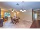 Spacious dining room with tile floors, chandelier, and natural light at 2189 De Narvik Dr, Henderson, NV 89044
