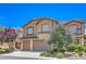 Charming two-story home with tile roof, two-car garage, and professionally landscaped yard at 2189 De Narvik Dr, Henderson, NV 89044