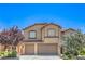 Charming two-story home with tile roof, two-car garage, and professionally landscaped yard at 2189 De Narvik Dr, Henderson, NV 89044