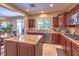 Modern kitchen with stainless steel appliances, granite countertops, and wooden cabinets at 2189 De Narvik Dr, Henderson, NV 89044