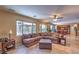 Cozy living room with ample seating, ceiling fan, and natural light from large windows at 2189 De Narvik Dr, Henderson, NV 89044