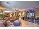 Spacious living room featuring a large sectional, bar area, and access to kitchen at 2189 De Narvik Dr, Henderson, NV 89044
