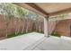 Landscaped backyard with trees along the perimeter and a covered patio, creating a private outdoor space at 2231 Desert Prairie St, Las Vegas, NV 89135