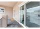 Covered balcony with glass sliding door overlooking a neighbor's property and the sky at 2231 Desert Prairie St, Las Vegas, NV 89135