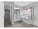 Bright bathroom featuring a soaking tub, walk-in shower, and an attached closet at 2231 Desert Prairie St, Las Vegas, NV 89135