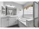 Bright bathroom featuring a soaking tub, walk-in shower, and an oversized vanity at 2231 Desert Prairie St, Las Vegas, NV 89135