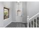 Bright entryway featuring wood-look floors, a decorative front door, and a staircase at 2231 Desert Prairie St, Las Vegas, NV 89135