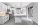 Open kitchen with an island, stainless steel appliances, and access to the backyard through sliding glass doors at 2231 Desert Prairie St, Las Vegas, NV 89135