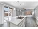 Kitchen island with white countertop, stainless steel sink, and pendant lighting at 2231 Desert Prairie St, Las Vegas, NV 89135