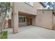 Covered parking area featuring a stucco exterior, secure gated access, and adjacent turf landscaping at 2231 Desert Prairie St, Las Vegas, NV 89135