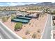 Aerial shot shows tennis courts and desert landscape along paved streets in a planned residential community at 2326 Garnet Star St, Henderson, NV 89044