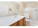 Well-lit bathroom featuring a vanity with a white countertop, wood cabinets, and a shower-tub combination at 2326 Garnet Star St, Henderson, NV 89044