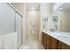 Well-lit bathroom featuring a double sink vanity and a glass-enclosed shower at 2326 Garnet Star St, Henderson, NV 89044