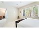A cozy bedroom with a large window offering natural light and a glimpse of the outdoors at 2326 Garnet Star St, Henderson, NV 89044
