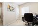 A functional home office with a comfortable chair, desk, and a window, ideal for remote work or study at 2326 Garnet Star St, Henderson, NV 89044