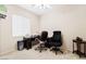 Bright home office space featuring two chairs, a desk, a window and neutral walls at 2326 Garnet Star St, Henderson, NV 89044