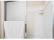 A clean shower with sliding glass doors and a white shower surround with a built-in shelf at 2326 Garnet Star St, Henderson, NV 89044