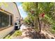 Side yard with charming walkway and a barbecue grill at 2326 Garnet Star St, Henderson, NV 89044