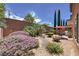 Serene backyard features a rock water feature, tall grasses, and patio space at 2373 Rue Royale St, Henderson, NV 89044