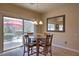 Cozy dining area featuring a glass table and access to the backyard patio at 2373 Rue Royale St, Henderson, NV 89044